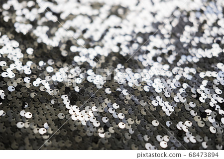 Sequin fabric texture. Shiny silver sparkling background. Clothing piece of glitter metallic for a glamorous party, celebration. Close-up. Sequin fabric texture. Shiny silver sparkling background. Clothing piece of glitter metallic for a glamorous party, celebration. Close-up. 68473894