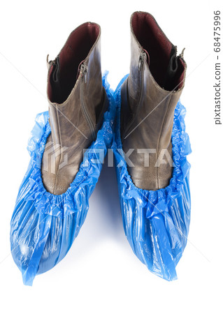 Blue protective shoe covers on female shoes Blue protective shoe covers on female shoes 68475996