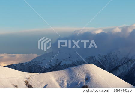 Snowy off-piste slope with tracks from skis and Snowy off-piste slope with tracks from skis and 68476039