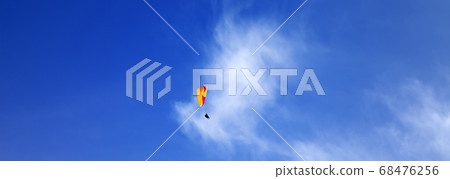 Skydivers in blue sky at sun day 68476256
