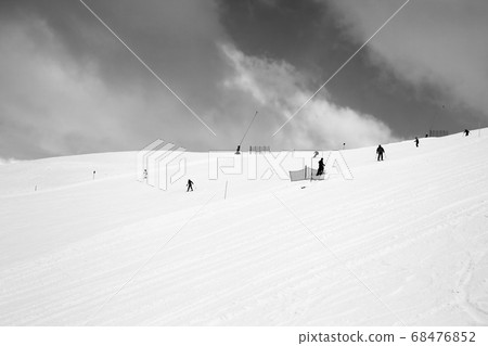 Skiers on trace for ski prepared by snowcat and Skiers on trace for ski prepared by snowcat and 68476852