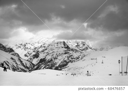 Snowy ski slope with skier and snowboarder in high Snowy ski slope with skier and snowboarder in high 68476857