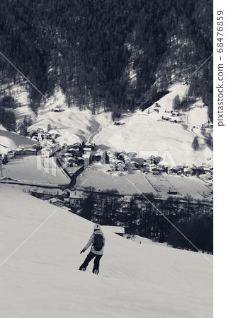 Snowboarder on snowy ski slope in high winter Snowboarder on snowy ski slope in high winter 68476859