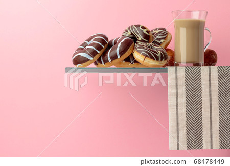 Chocolate donuts and latte on a black background. Chocolate donuts and latte on a black background. 68478449