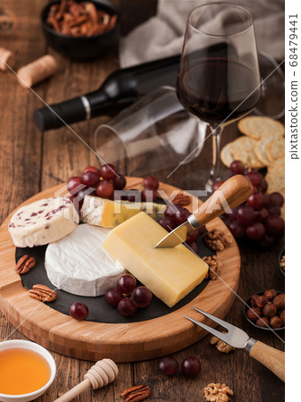 Glass and bottle of red wine with selection  68479441