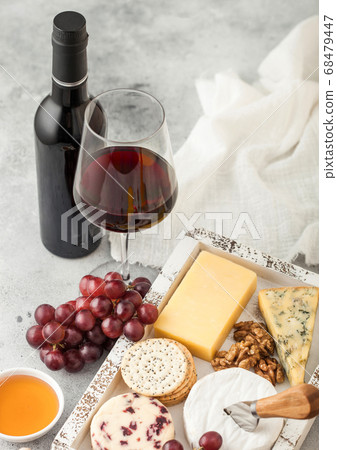 Glass and bottle of red wine with selection  68479447