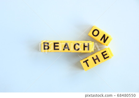 on the beach concept, inscription in yellow letters on a blue background on the beach concept, inscription in yellow letters on a blue background 68480550