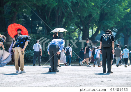 Tokyo cityscape in Japan People who bow deeply under the great torii gate of Yasukuni Shrine in the heat of summer = August 15 "End of the war" 68481483