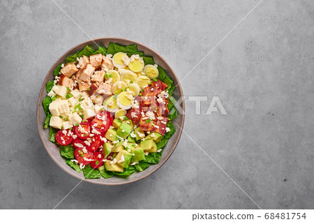 Cobb Salad in gray matte bowl on concrete table Cobb Salad in gray matte bowl on concrete table 68481754