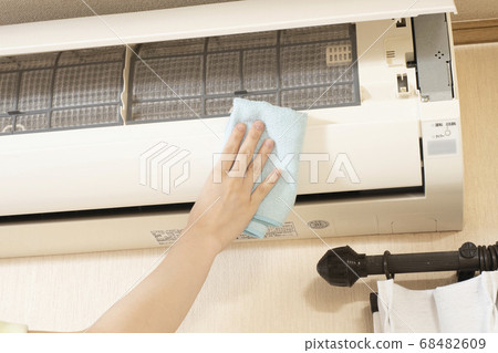 At the hands of a female worker doing house cleaning to clean the air conditioner At the hands of a female worker doing house cleaning to clean the air conditioner 68482609