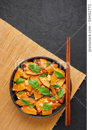 Pad Faktong or Thai Stir-fried Pumpkin in black bowl 68482773