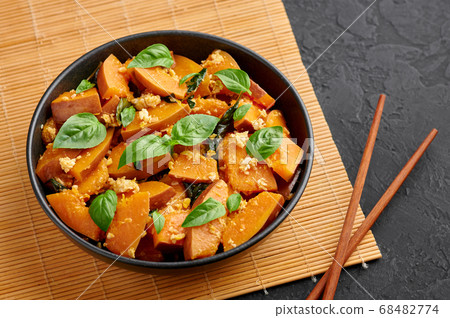 Pad Faktong or Thai Stir-fried Pumpkin in black bowl 68482774