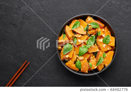 Pad Faktong or Thai Stir-fried Pumpkin in black bowl 68482776