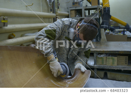 Worker fitting part of fuselage of a light plane at the assembly shop 68483323