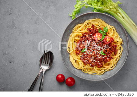 Pasta Spaghetti Bolognese in gray bowl on concrete table top Pasta Spaghetti Bolognese in gray bowl on concrete table top 68483330