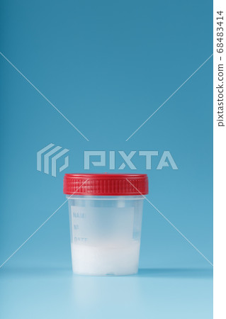 Semen in a test container with a red lid on a blue Semen in a test container with a red lid on a blue 68483414