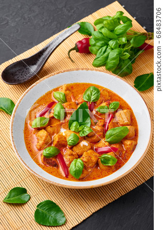 Thai Panang Chicken Curry in white plate at black table top  68483706