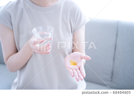 A woman drinking supplements 68484805