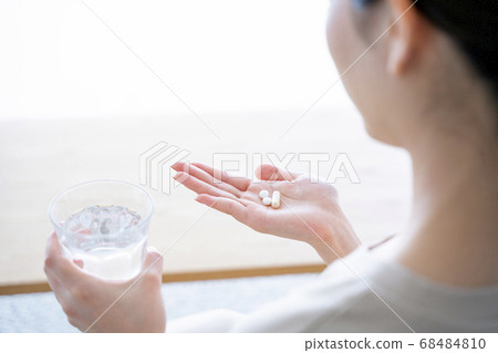 Woman taking medicine 68484810