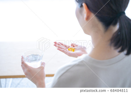 A woman drinking supplements 68484811