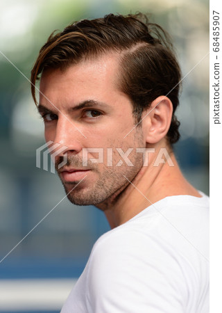 Young handsome Hispanic man at the padel court 68485907