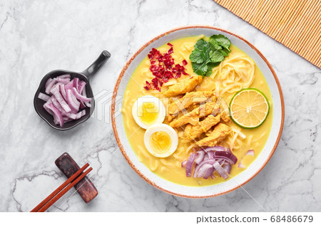 Ohn No Khao Swe on white marble background. Myanmar Coconut Milk Noodle Soup Ohn No Khao Swe on white marble background. Myanmar Coconut Milk Noodle Soup 68486679