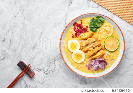 Ohn No Khao Swe on white marble background. Myanmar Coconut Milk Noodle Soup Ohn No Khao Swe on white marble background. Myanmar Coconut Milk Noodle Soup 68486680