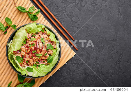 Laab Gai - Thai Minced Chicken Salad in black bowl 68486904