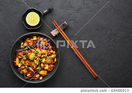 Kung Pao Paneer at black slate background.  68486913