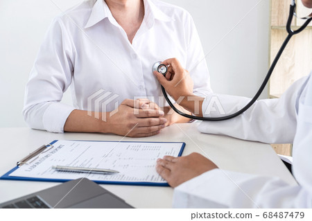 Doctor using a stethoscope checking patient about Doctor using a stethoscope checking patient about 68487479