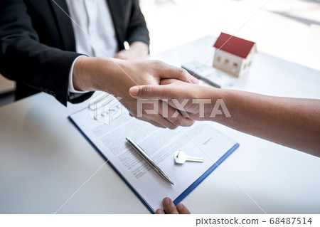 Real estate agent are shaking hands after good Real estate agent are shaking hands after good 68487514