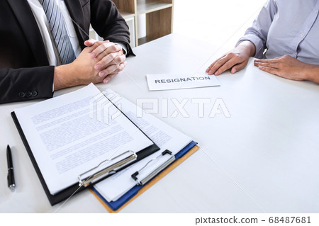 Employee sending resignation letter to boss Employee sending resignation letter to boss 68487681
