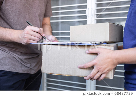Young Delivery man deliver box parcel package and Young Delivery man deliver box parcel package and 68487759