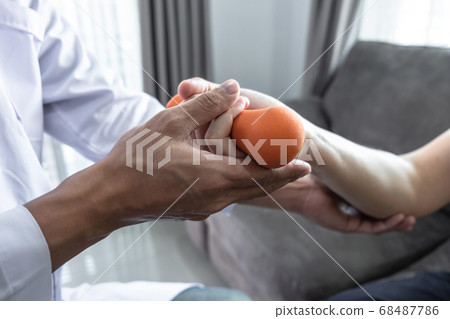 Doctor physiotherapist treating rehabilitation arm 68487786