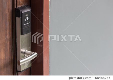 Smart card door key lock system in hotel. Hotel electronic lock on wooden door 68488753