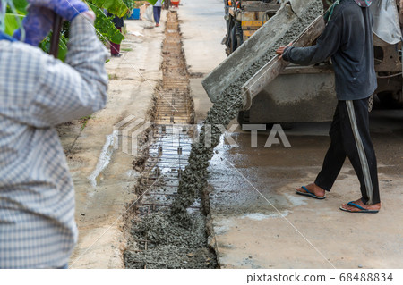 Mixed concrete pouring at construction site 68488834