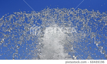 Fountain drops of pure water against a blue sky. Fountain drops of pure water against a blue sky. 68489196