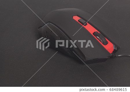 Computer modern gaming mouse on black mouse pad 68489615