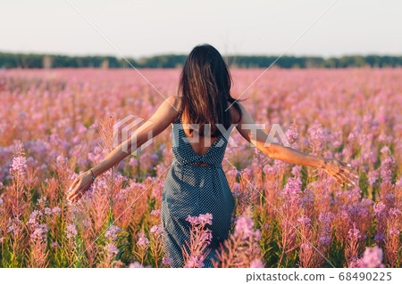 Girl on blooming Sally flower field. Lilac flowers and woman. Girl on blooming Sally flower field. Lilac flowers and woman. 68490225