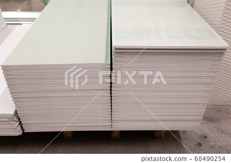 Pallet with Drywall sheets plasterboard in the building warehouse store. Pallet with Drywall sheets plasterboard in the building warehouse store. 68490254