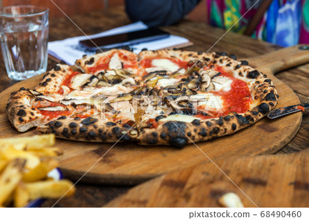 Portobello Italian pizza on the thin base with melted mozzarella Portobello Italian pizza on the thin base with melted mozzarella 68490460