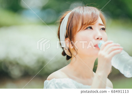 A woman drinking water 68491113