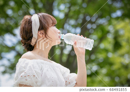 A woman drinking water 68491855
