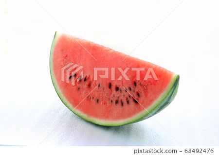 A 1/8 slice of red watermelon shot diagonally from the side over a white background A 1/8 slice of red watermelon shot diagonally from the side over a white background 68492476