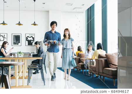 Men and women walking in the cafe Men and women walking in the cafe 68494617