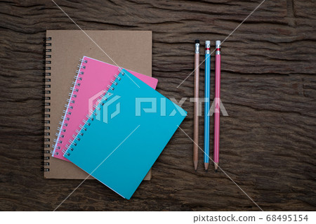 Pencil and book mockup on the old wood desk at the background, Flat lay photo, top view Pencil and book mockup on the old wood desk at the background, Flat lay photo, top view 68495154