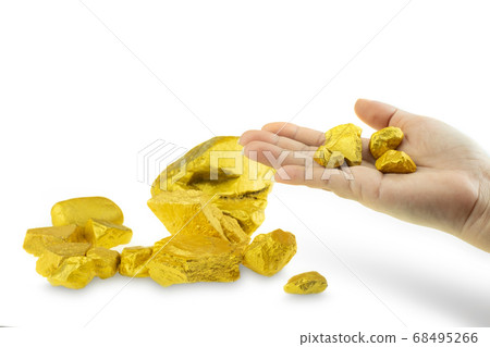 Woman hand holding gold nugget at the white background Woman hand holding gold nugget at the white background 68495266