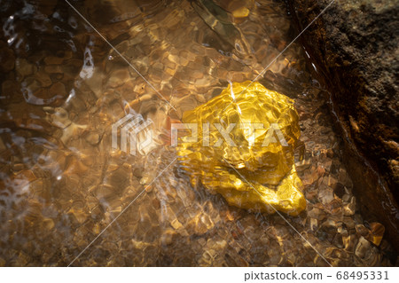 Pure gold nugget ore found in mine with natural underwater sources Pure gold nugget ore found in mine with natural underwater sources 68495331