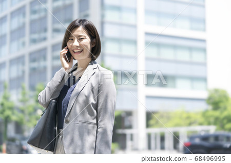 Business woman to call with smartphone Business woman to call with smartphone 68496995