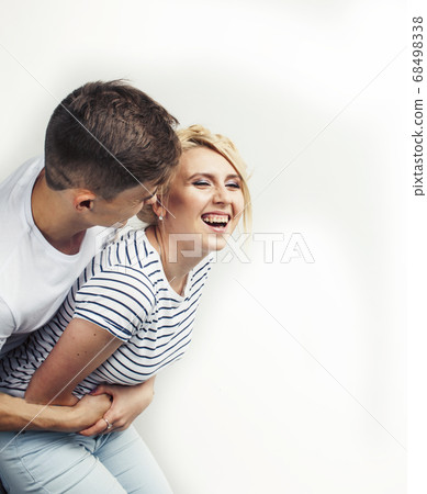 young pretty teenage couple, hipster guy with his girlfriend happy smiling and hugging isolated on white background, lifestyle people concept 68498338